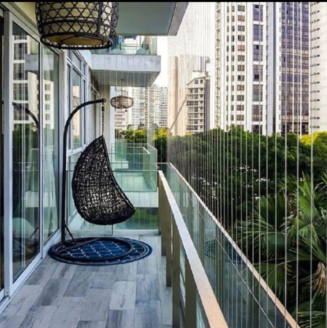 Luxury balcony with hanging chair and invisible grill cable installation